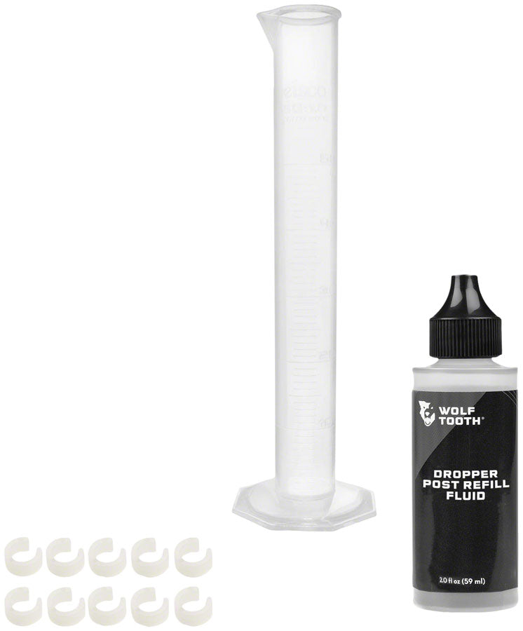 Load image into Gallery viewer, Wolf Tooth Resolve Dropper Post Service Kit - Refill Fluid 2oz Graduated Cylinder 10 Travel Adjustment Spacers
